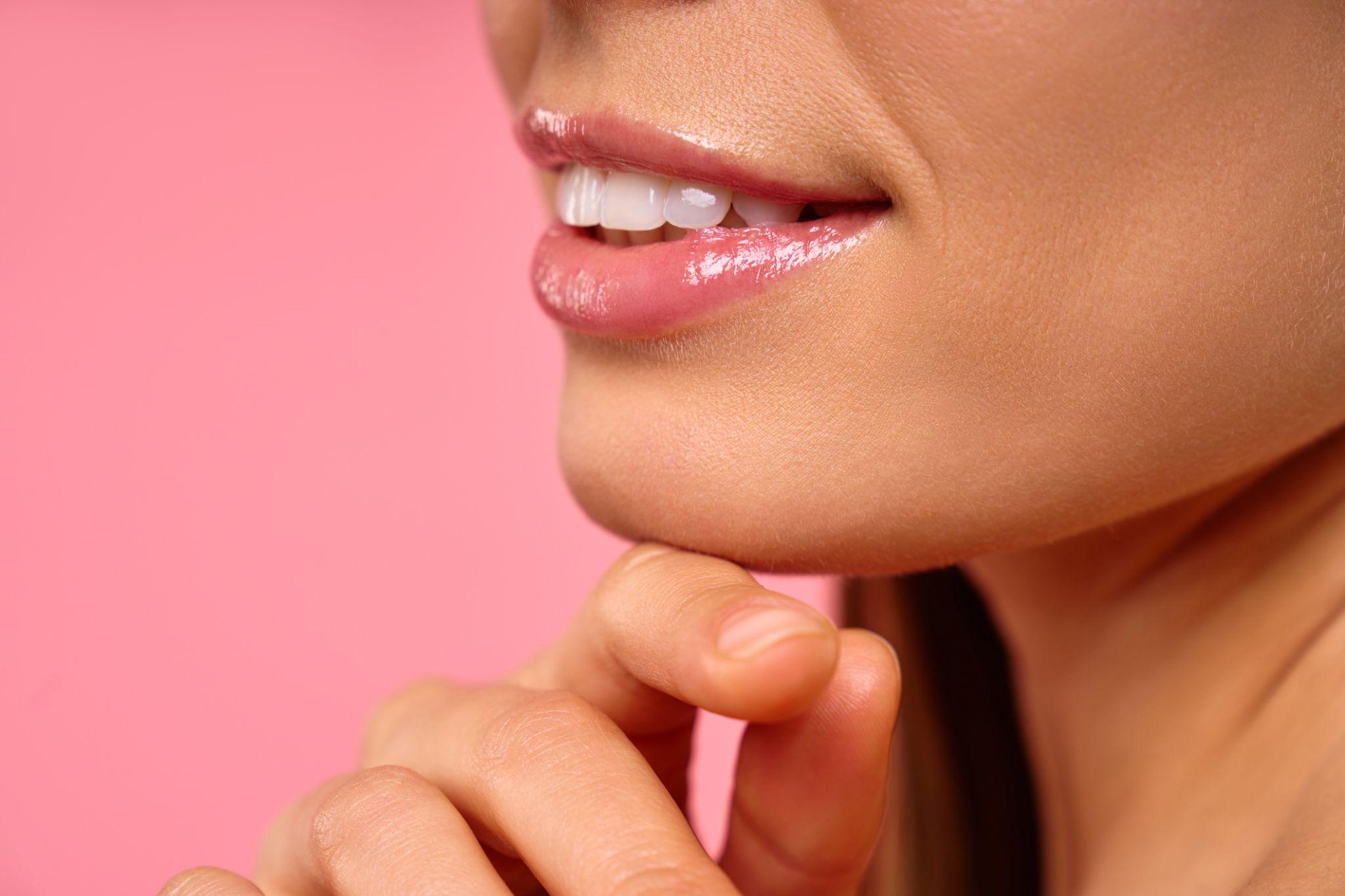 A woman with a beautiful smile shows off the results of cosmetic dentistry.
